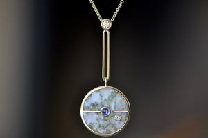 
            
                Load image into Gallery viewer, Close up of  The signature Compass Pendant with Green Agate and Tanzanite by Retrouvai is a pendant necklace with stone inlay that is accented with a center gem stone and a white diamond. 
            
        