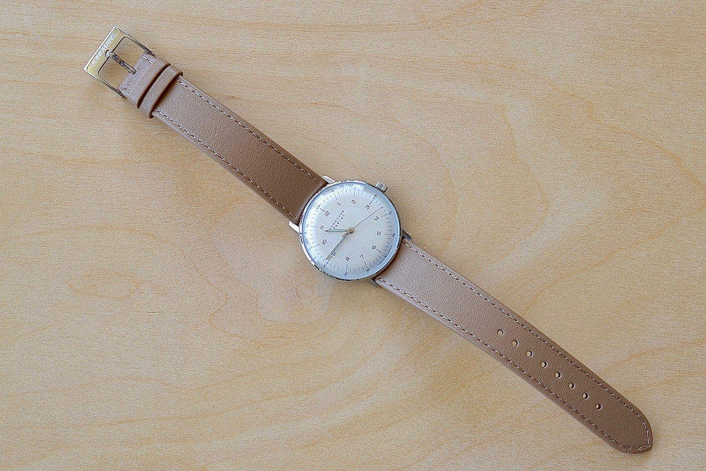 Full image of Max Bill 34mm Hand-wound Watch in White Dial with Numbers designed for Junghans in 1961remains virtually unchanged. 34mm hand wound watch with black face and numbers with hand winding movement J805.1 (ETA 2801-2) and a sapphire crystal,  42 Hour Power Reserve in 316L stainless steel case available at OK.