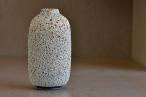 
            
                Load image into Gallery viewer, Tall Heather Rosenman cream to gray ceramic bottle vase in volcanic glaze.
            
        