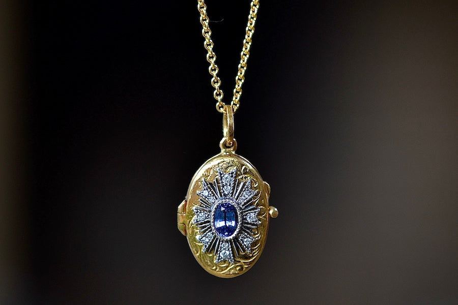 Close up of Arman Sarkisyan Blue sapphire locket in 22k yellow gold with diamonds.
