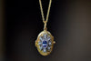 Close up of Arman Sarkisyan Blue sapphire locket in 22k yellow gold with diamonds.