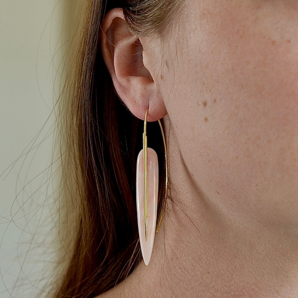 Wearing the feather earrings in pink opal.