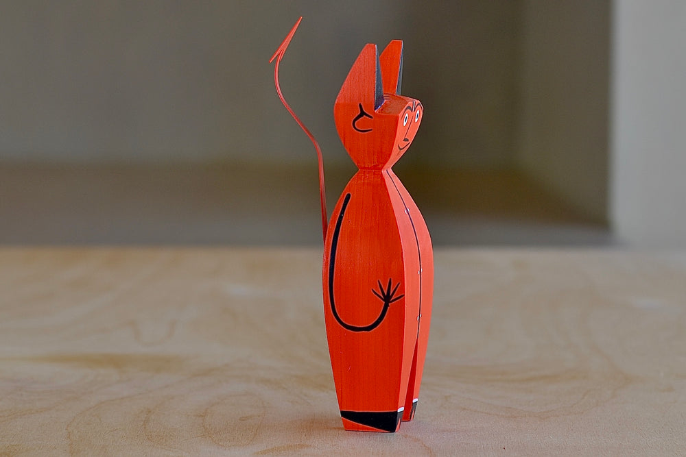 
            
                Load image into Gallery viewer, Side view of the The Wooden Little Devil is a bright red decorative figurine that is part of the Alexander Girard doll collection.
            
        