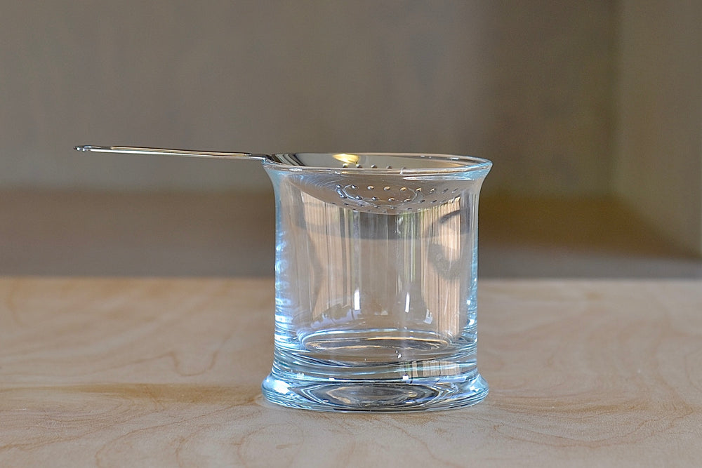 Japanese Julep Strainer in Stainless Steel on top of a mixing glass. Made in Yukiwa, Japan.