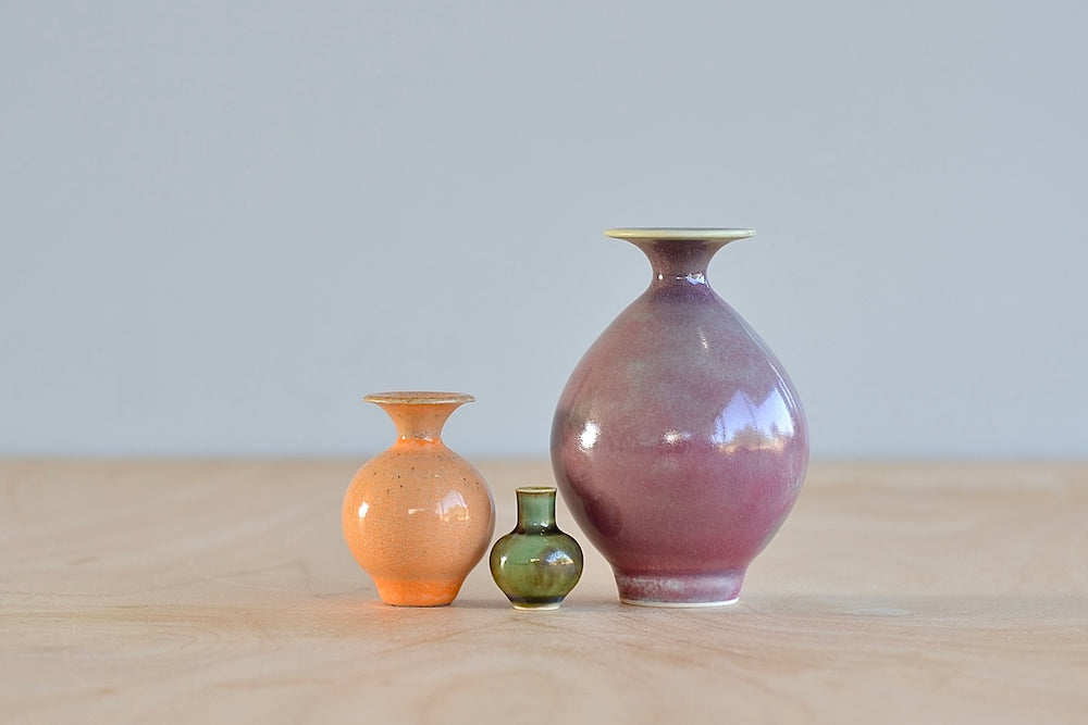 Miniature Hand Thrown Ceramic Vase Trio by Yuta Segawa in Peach, Rose and Green on white background.