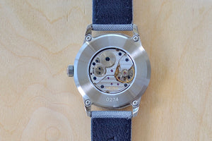 
            
                Load image into Gallery viewer, Back of Weiss Watch 38mm Standard Issue Field Watch with White Dial is manually wound, made with American parts, featuring Super Luminova hands and markers for all everyday adventures..
            
        