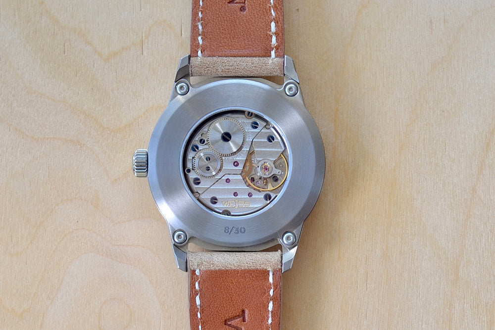 
            
                Load image into Gallery viewer, Back of Limited Edition 38MM Standard Issue Field Watch in Pink Sand and titanium by Cameron Weiss. Pink dial and manually wound with American parts, hands and markers. Series of 30.
            
        