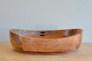 Alternate side of Circle Factory bowl in Maple by Geoarge Peterson is a blonde wood apple bowl with repairs deatail.