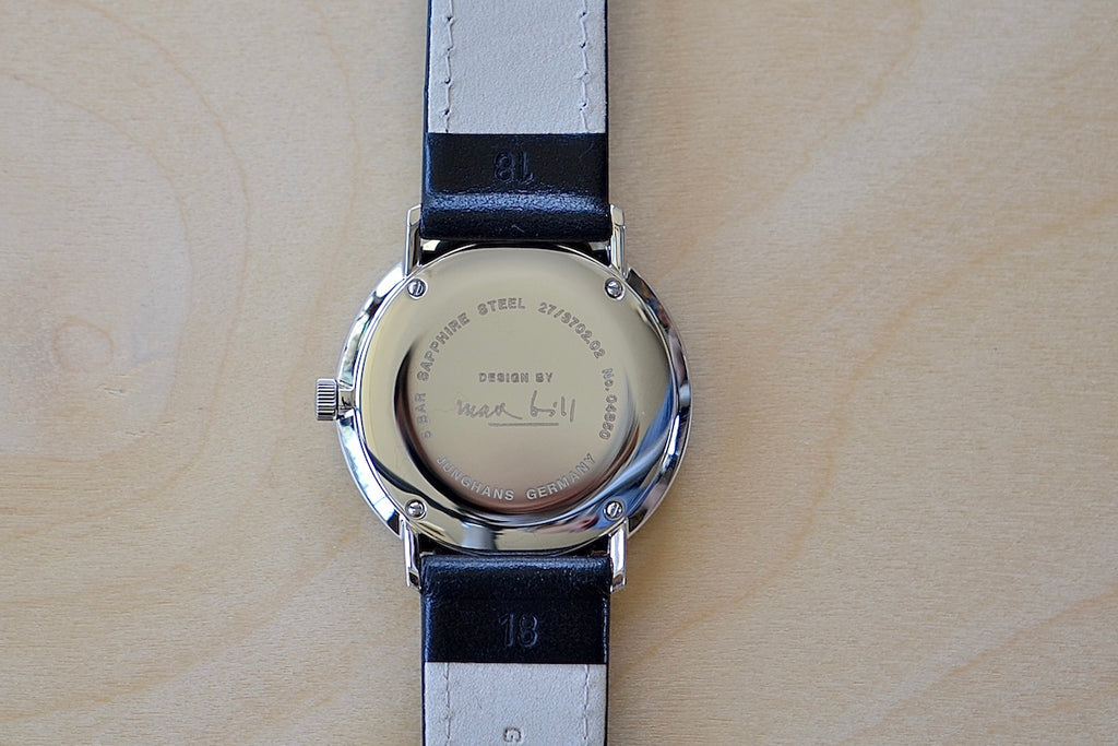 Back of Max Bill 34mm Hand wound Watch Black Dial with Numbers designed for Junghans in 1961 and virtually unchanged. 34mm hand wound watch with black face and numbers.