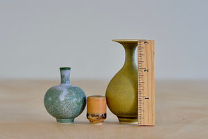 Miniature Hand Thrown Ceramic Vase Trio in Green Purple, Ochre and orange with ruler for scale by Yuta Segawa.