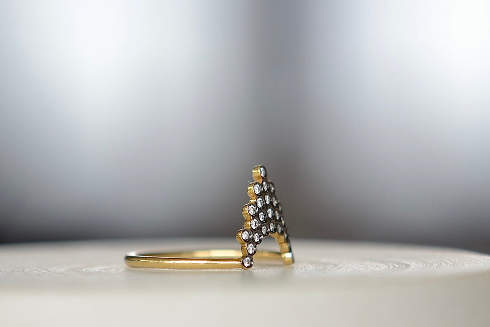 Alternate view of Side view of Pétale  Ring in size 6.5 by Yannis Sergakis is a triangular formation of twenty-five bezel set and rhodium plated round cut diamonds on a gold band in 18k gold. Minimalist and designed to be worn every day.