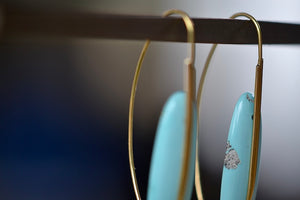 Close up of Feather Earrings in Turquoise with natural inclusions and 18k gold hooks by Rachel Atherley.