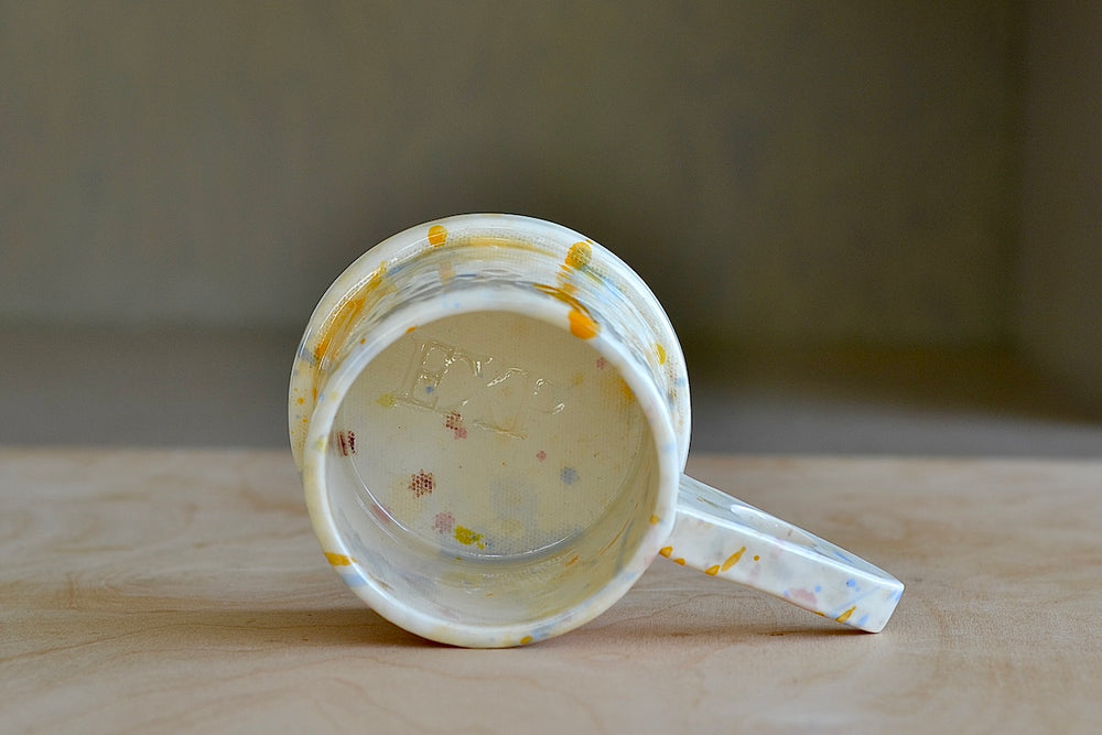 Stamped inside of EXP standard splatter mug in yellow drip by Peter Shire and Echo Park Pottery. 