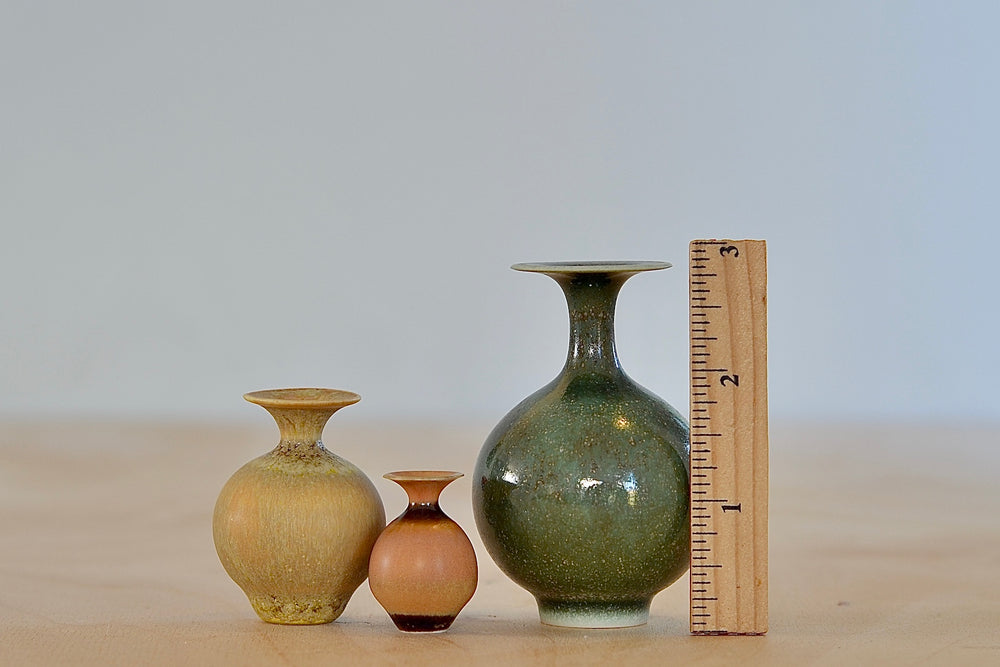 Miniature Hand Thrown Ceramic Vase Trio in Green, Ochre and Orange with a ruler for scale and made by Yuta Segawa.