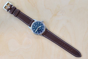 
            
                Load image into Gallery viewer, Full view of Weiss Watch 38mm Automatic Issue Field Watch with Navy Blue Dial and date, shown with dark brown Horween Leather strap. This watch is made with American parts, featuring Super Luminova hands and markers. 
            
        