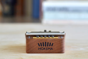 Side view of five finger (metal tines) kalimba in solid cherry wood.
