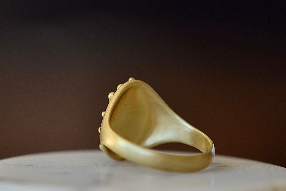 Back of Encrusted Lotus signet ring by Polly wales in green and blue sapphires with white diamonds in 18k polished yellow gold.