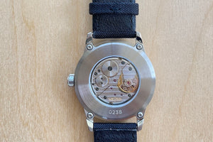 
            
                Load image into Gallery viewer, Back of Weiss Watch 38mm Standard Issue Field Watch with Black Dial is manually wound, made with American parts, featuring Super Luminova hands and markers for all everyday adventures..
            
        