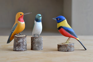 Wooden Band decorative irds from Brazil, showing two hummingbirds and one colorful finch.