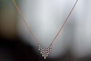 
            
                Load image into Gallery viewer, Close up of Charnières Pétale Pendant Necklace by Yannis Sergakis is twenty-Five (25) rhodium plated round cut diamonds that form a triangular pendant on an 18k gold chain.
            
        
