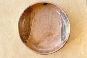 Birds eye view of Circle Factory bowl in Maple by Geoarge Peterson is a blonde wood apple bowl with repairs deatail.