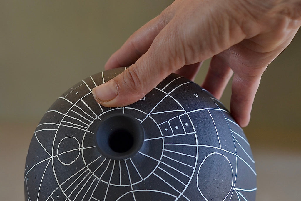 Top and close up of vase.