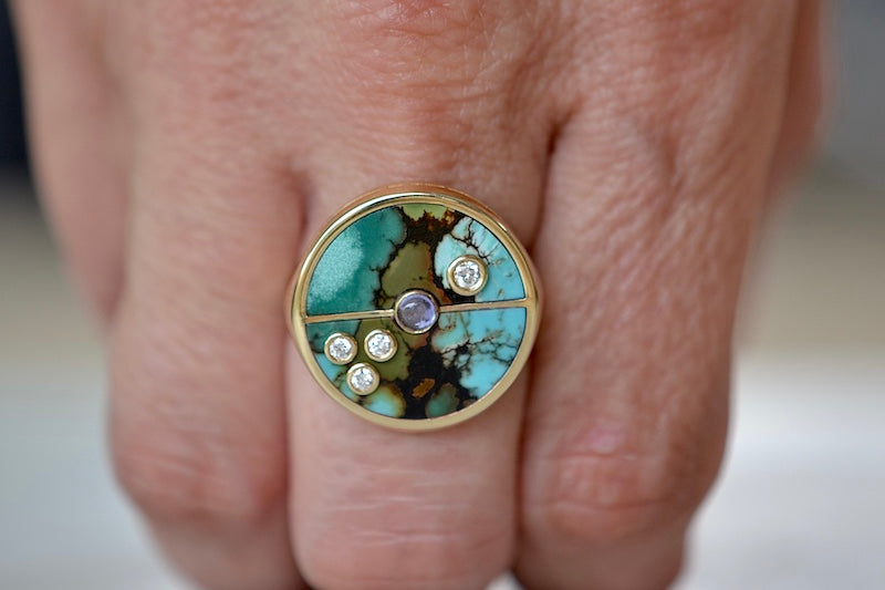
            
                Load image into Gallery viewer, Wearing the Retrouvai Turquoise Compass Signet ring with Diamonds and tanzanite accent stone in 14k yellow gold and inlay.
            
        
