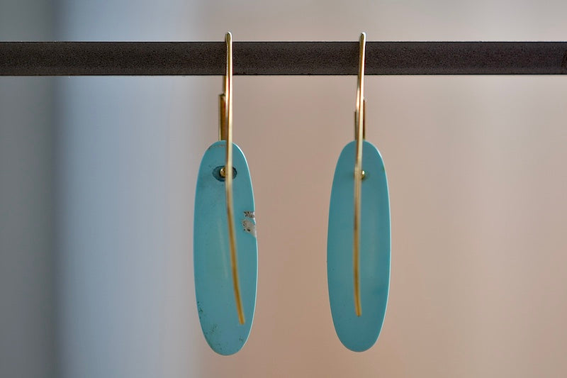 Back view of Feather Earrings in Turquoise with natural inclusions and 18k gold hooks by Rachel Atherley.