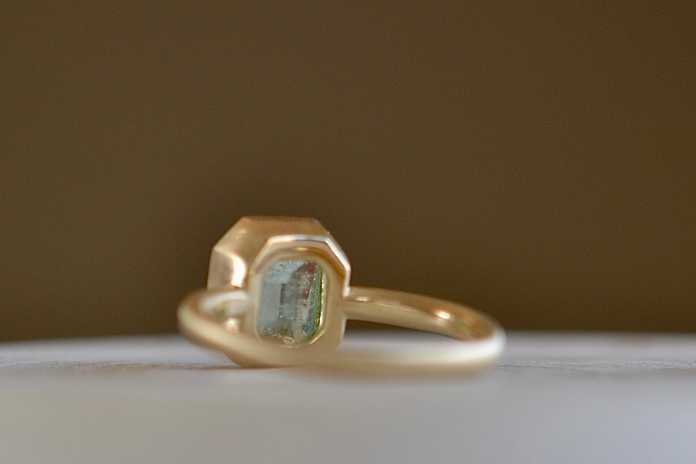 
            
                Load image into Gallery viewer, Alternate view of the simple Emerald Rectangular ring by Elizabeth Street made with a pale Columbian emerald.
            
        