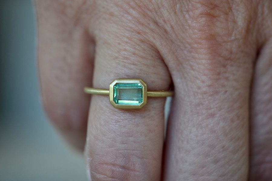 
            
                Load image into Gallery viewer, Wearing the Simple Green Emerald Ring by Elizabeth Street Jewelry.
            
        