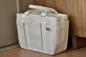 I'M OK Tote in heavy canvas by Thread-line and Matsunoya is a tool bag with five exterior pockets and two on the inside in white canvas made in Japan