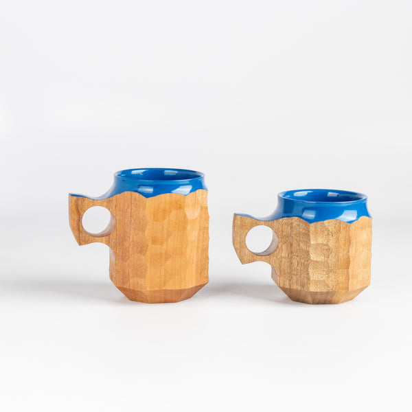 Large and medium Hybrid Blue Urushi Jin cups from Akihiro Woodworks is a hand carved tabunoki wood mug with vibrant blue lacquer on the rim and inside. The wood will darken over time. Made by Akihiro Woodworks in Kagoshima, Japan.