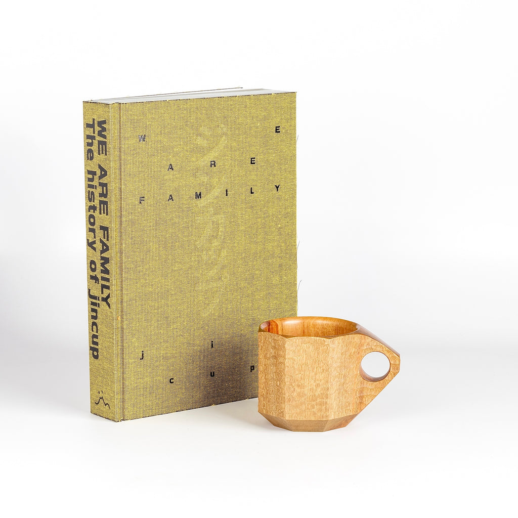 A special two piece set of The History of Jin cup "We are Family" and "jincup MOTHER," the hand carved mug that was created as a birthday gift for Jin's mother and sparked the design.&nbsp;Made by Akihiro Woodworks in Kagoshima, Japan.