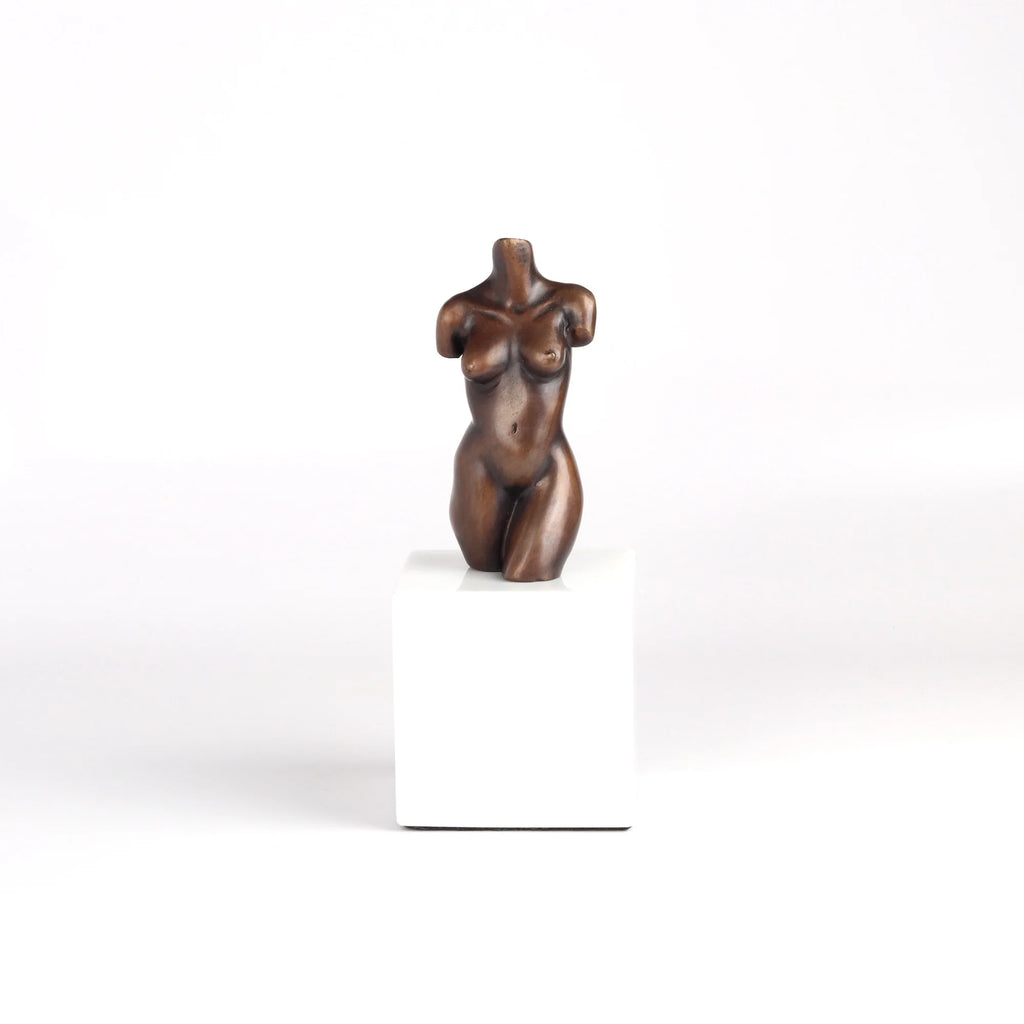 Anne Ricketts Torso Sculpture of modern woman in brass on white background.