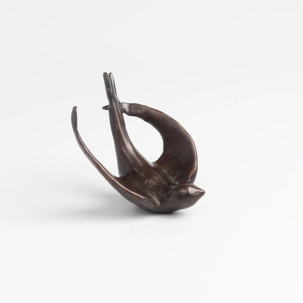 Bronze Object "Coming Home" (flying swallow) on white background by Anne Ricketts.