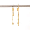 Arrow drop earrings in 18k with diamonds by Arman Sarkisyan are 45mm long arrowns in gold with white round cut diamonds on french hooks.