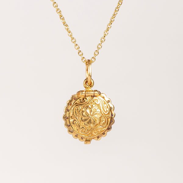 Engraved or carved back of Mini Lace locket with blue sapphire.