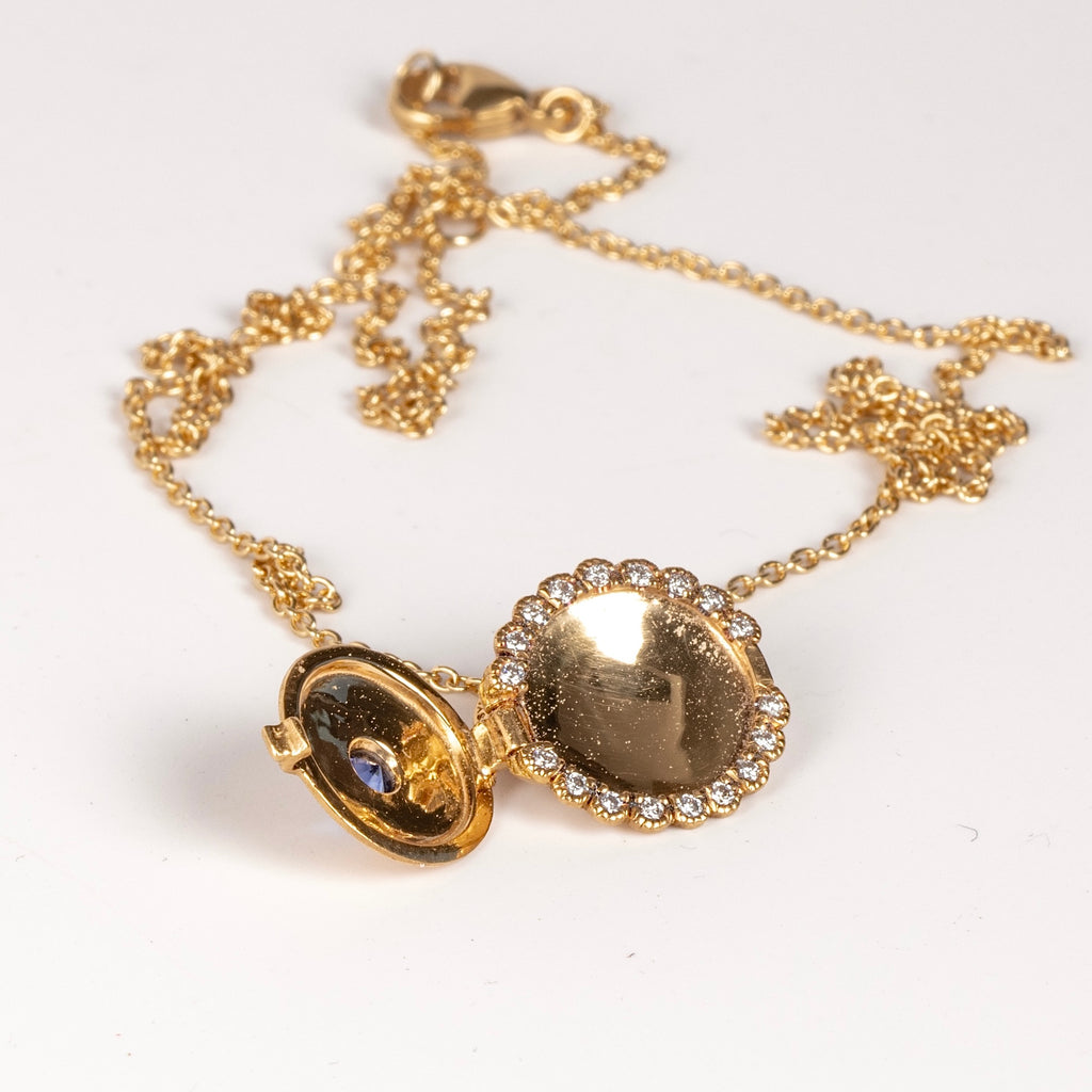Showing the Mini Lace locket with blue sapphire open.