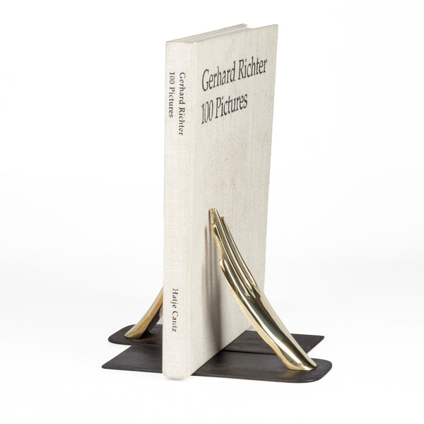 Aubock Bookends 1928 Hands bookends are polished brass and hand shape bookends 1928 with patinated base. Designed by Carl Auböck and handmade in Austria. Founded in 1906, the workshop is still owned and operated by the Auböck family (by Carl IV and V) from its original home, in a Vienna townhouse. OK has the largest selection of current Werkstätte Auböck production in the US and in stock, ready to ship.