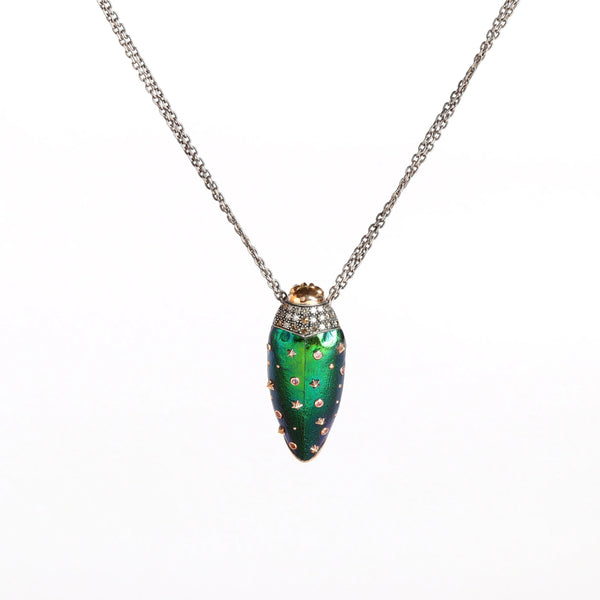 Scarab Star Necklace by Bibi Van Der Velden is a pendant necklace of a scarab in 18k rose gold and sterling with a sterling chain, white diamonds,  brown diamonds, a  scarab wing in amethyst with pink sapphire and tsavorite on white background.