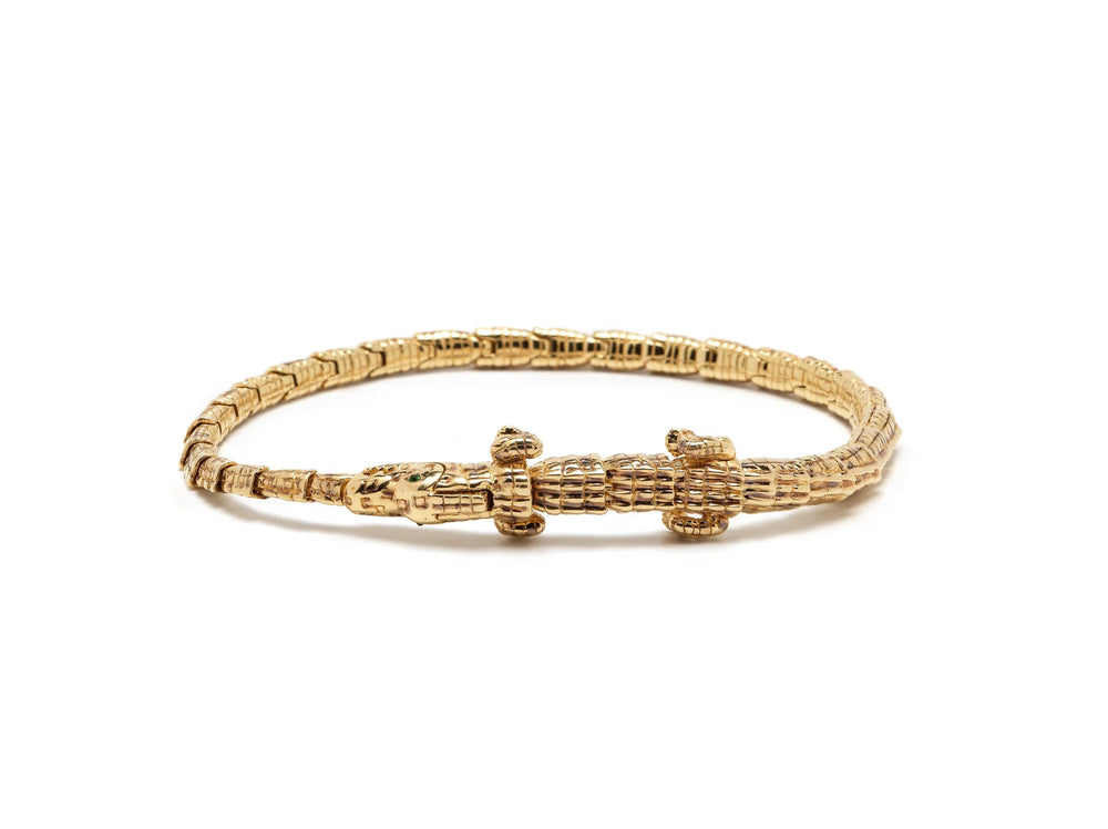 Full shot of Alligator Wrap Thin Bracelet by Bibi Van Der Velden is a tennis style bracelet in 18k yellow gold with tsavorite eyes.