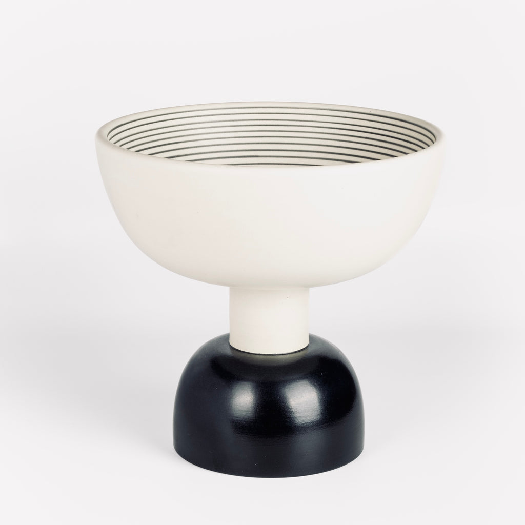 Ceramic Sottsass vessel Alzata Grande in black and white stripes on white background.