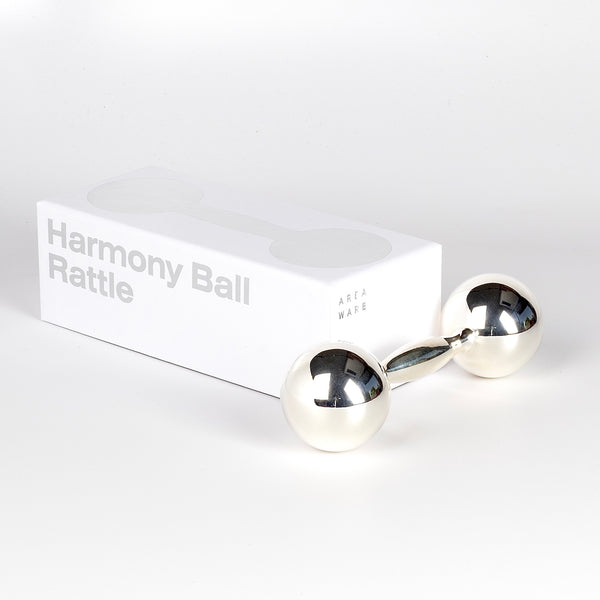 The double ball Harmony Ball Rattle in German silver and sterling designed by Noel Wiggins for Areaware.