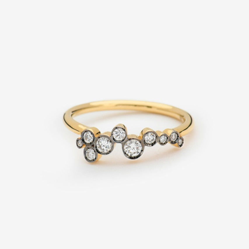Celeste 2 ring by Yannis Sergakis is a constellation of ten bezel set and rhodium plated round cut diamonds on a gold band in 18k gold. To remind you of the stars in the sky.