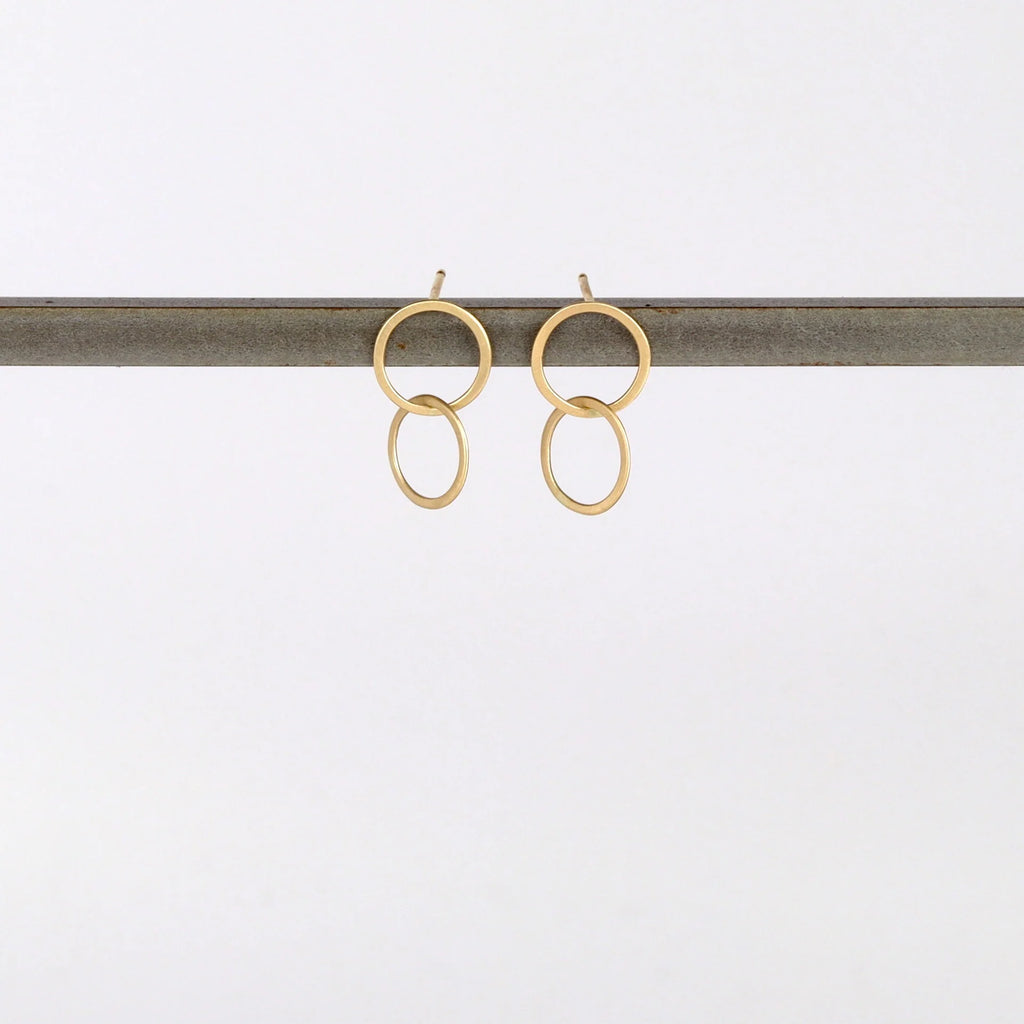 Double Circle Stud Earrings in matte 14k yellow gold designed and handmade by Carla Caruso on white background.
