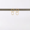 Double Circle Stud Earrings in matte 14k yellow gold designed and handmade by Carla Caruso on white background.