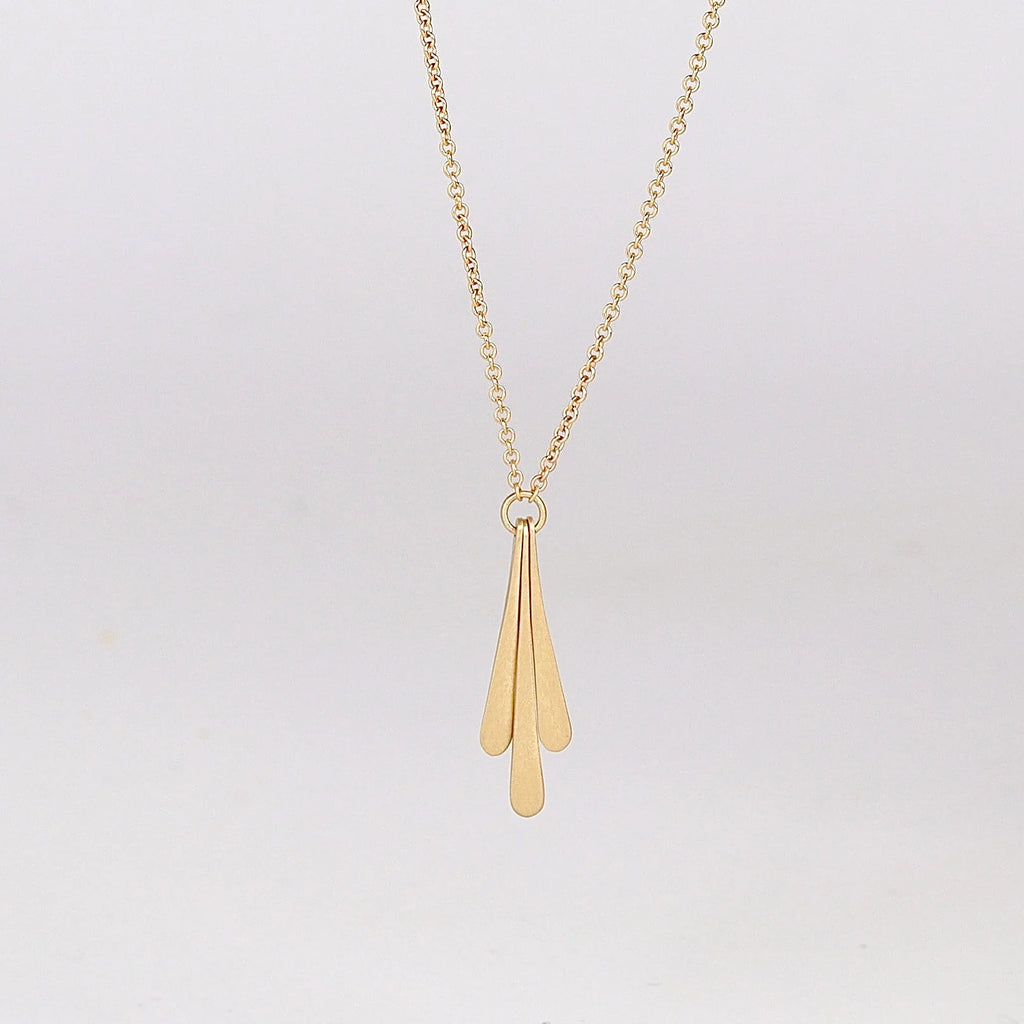 Close up of Triple Fringe Necklace on white background.