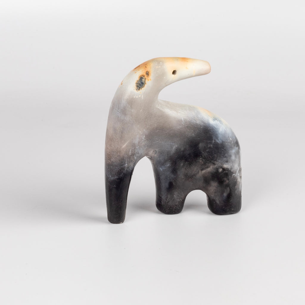 The ceramic creature is a one of a kind figurine formed from solid clay and refined by hand, this "one of a kind" ceramic creature is made out of white earthenware and white terra sigillata before getting pit fired in the wilderness. Made by Carol Horst in Los Angeles.
