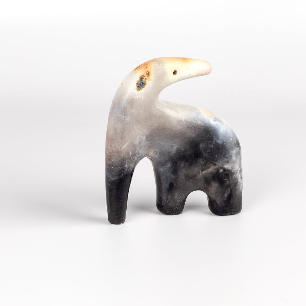 The ceramic creature is a one of a kind figurine formed from solid clay and refined by hand, this "one of a kind" ceramic creature is made out of white earthenware and white terra sigillata before getting pit fired in the wilderness. Made by Carol Horst in Los Angeles.