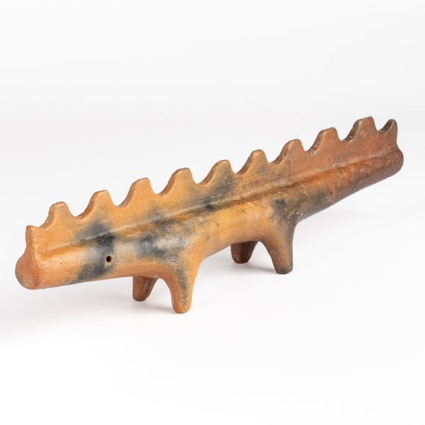 Ceramic Creature 10 is a figurine fformed from solid clay and refined by hand, this "one of a kind" ceramic creature is made out of red earthenware and red terra sigillata before getting pit fired in the wilderness. Made by Carol Horst in Los Angeles.